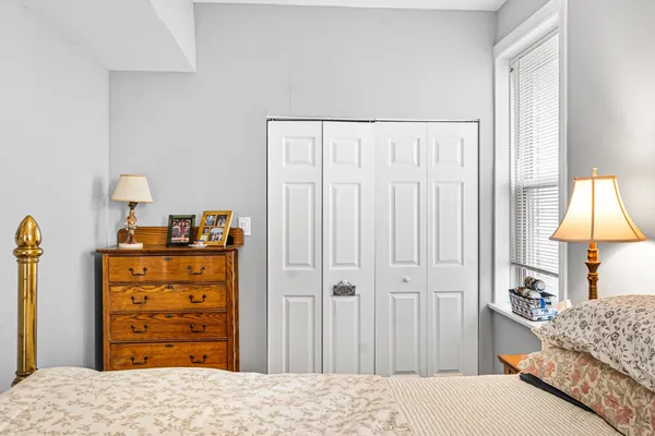 a bedroom with a bed and a closet