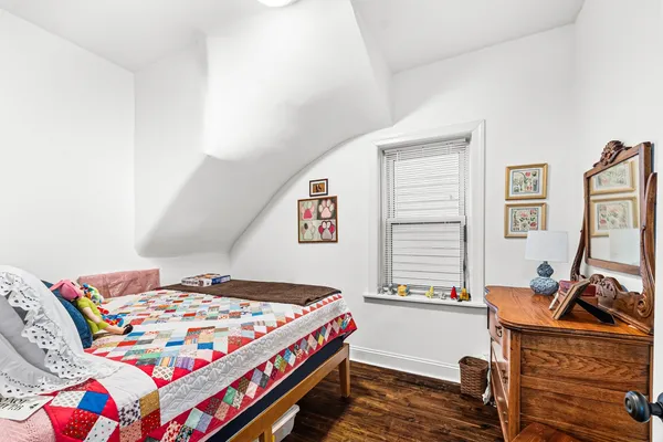 a bedroom with a bed and a desk
