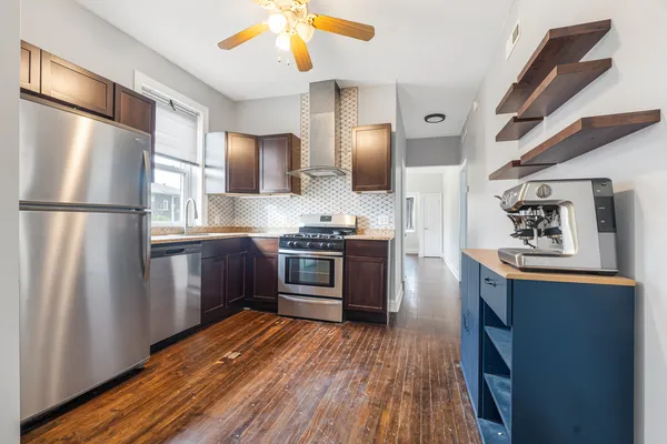a kitchen with stainless steel appliances a refrigerator and a stove