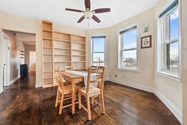 a dining room with wooden floor and a window