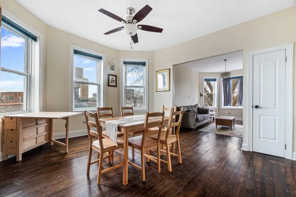 a view of a dining room with furniture window and wooden floor