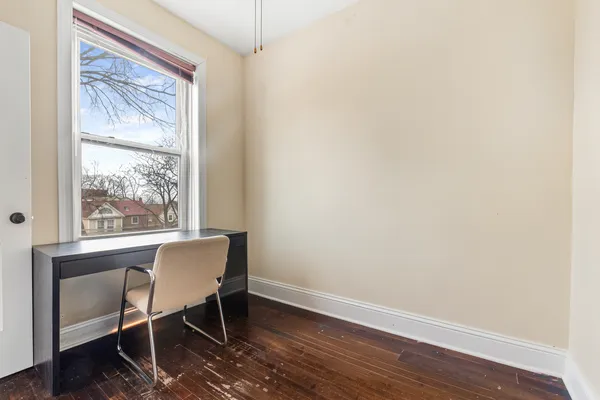 a workspace with wooden floor and a window