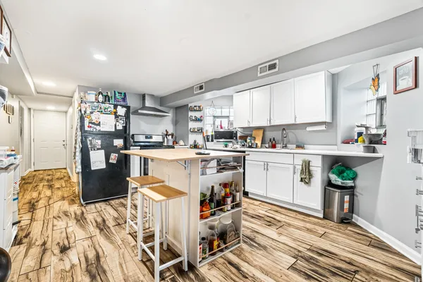 a kitchen with stainless steel appliances granite countertop a refrigerator sink and cabinets