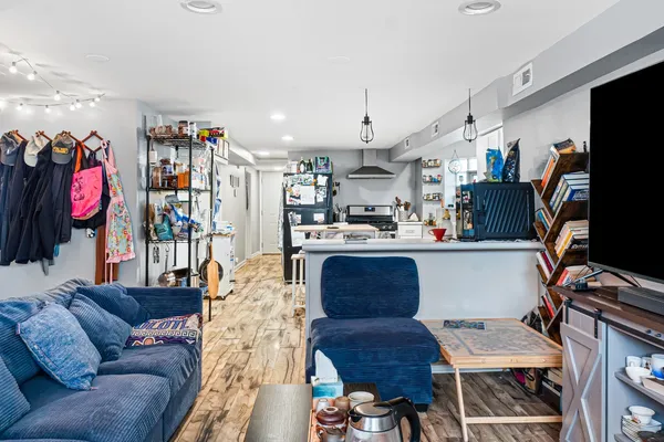 a living room with furniture a rug and a flat screen tv