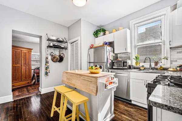 a kitchen with stainless steel appliances a stove a sink and a refrigerator
