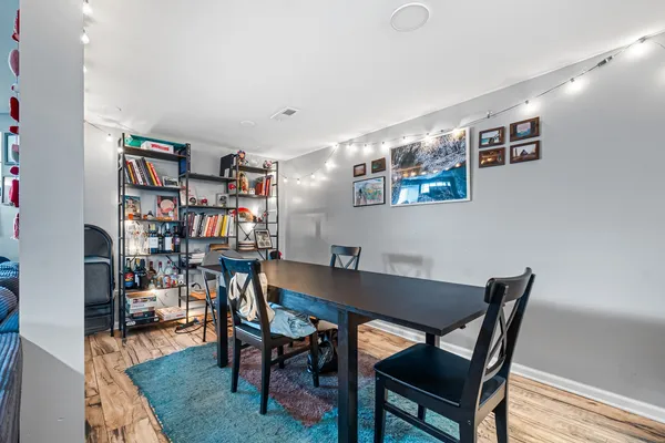 a view of a dining room with furniture and wooden floor