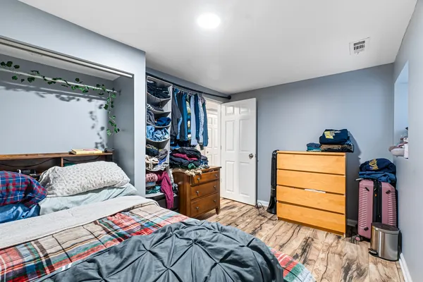 a bedroom with a bed and a closet