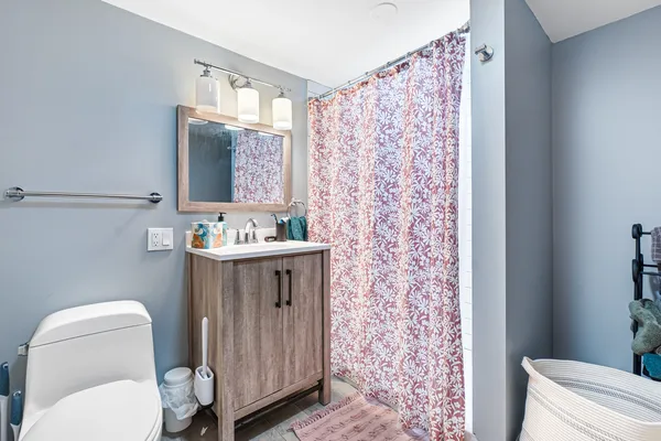 a bathroom with a sink toilet and mirror