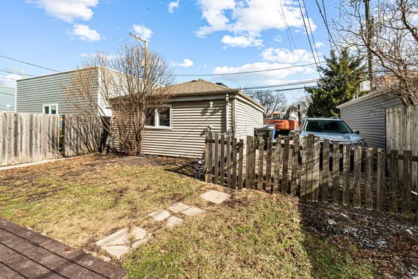 a view of a house with a wooden fence