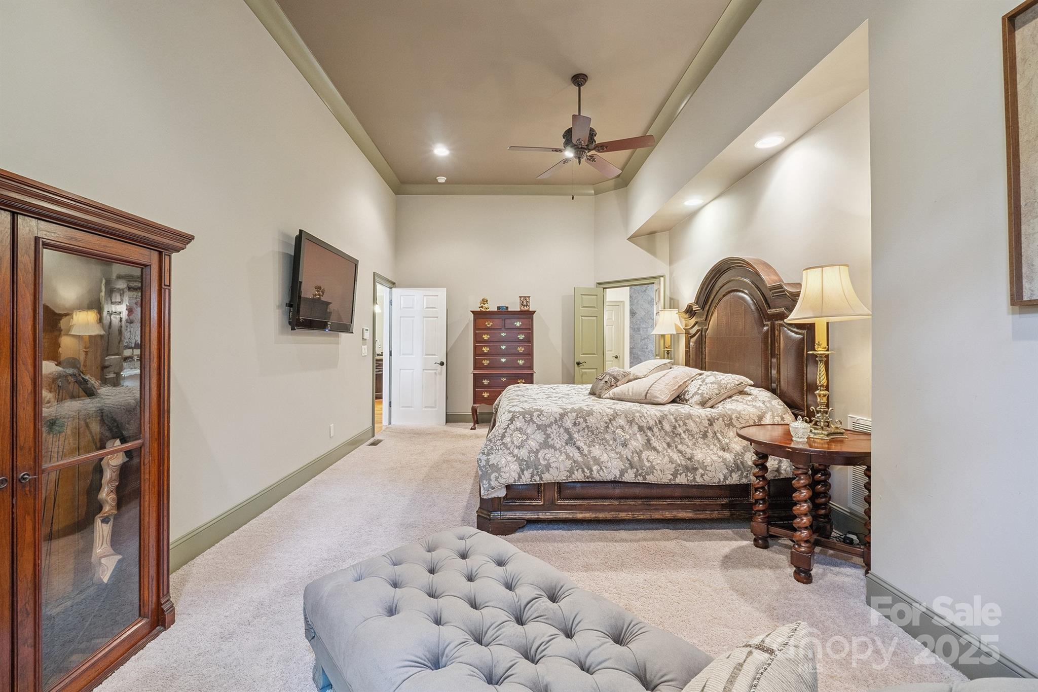 8304 Renee Ford Road Stanfield, NC 28163 - Photo 18 of 30 a bedroom with a large bed and a flat tv screen on dresser