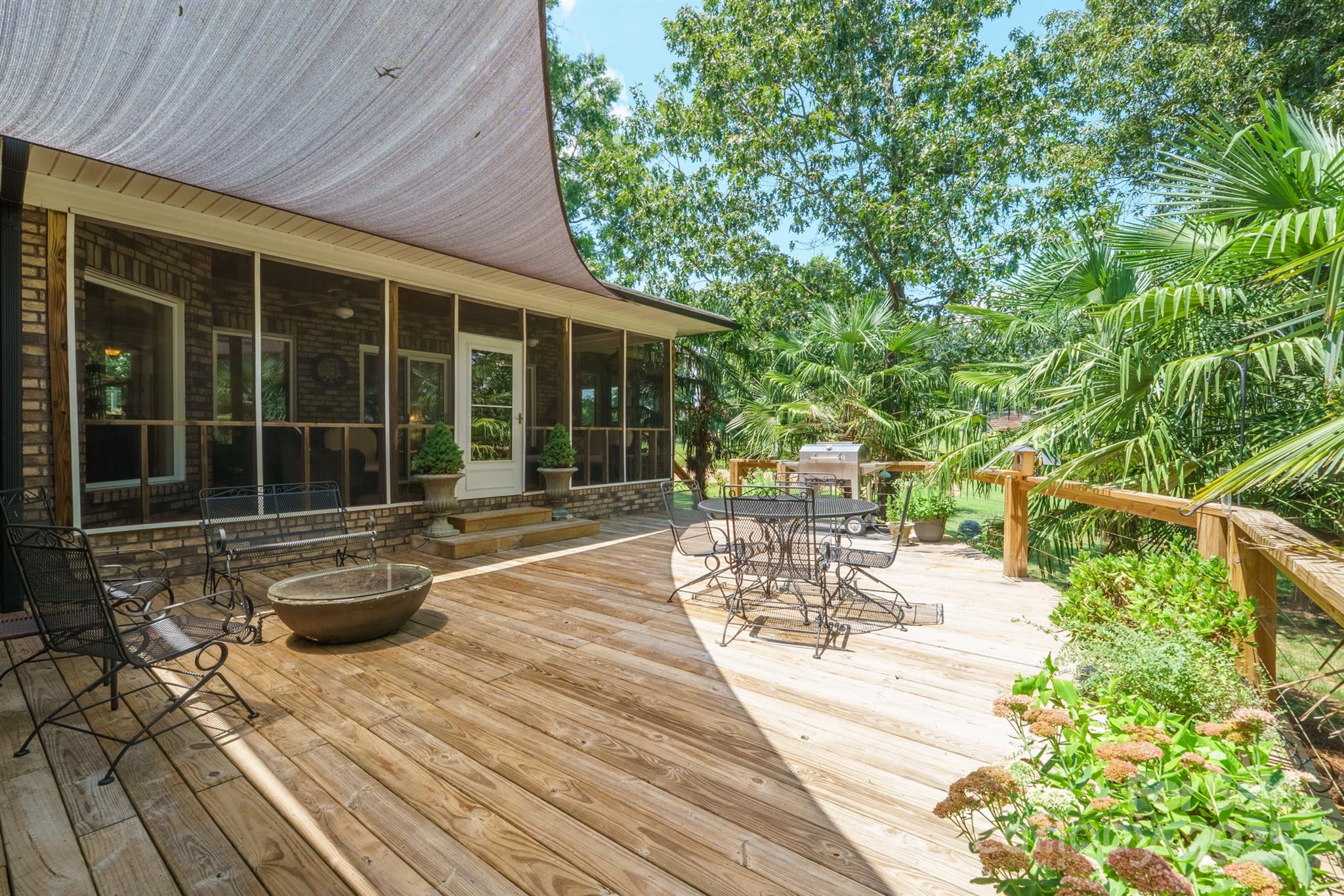 8304 Renee Ford Road Stanfield, NC 28163 - Photo 28 of 30 a view of a patio with table and chairs and wooden floor