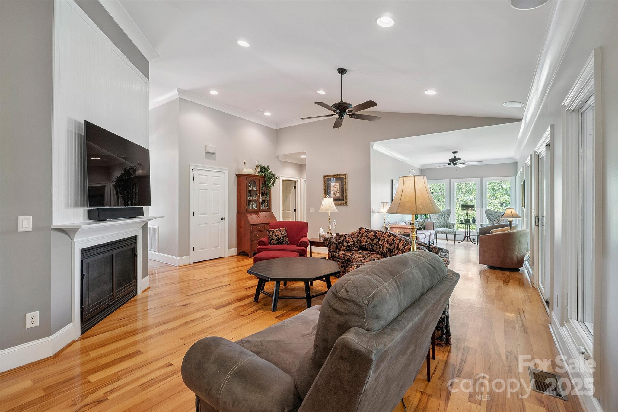 8304 Renee Ford Road Stanfield, NC 28163 - Photo 5 of 30 a living room with furniture a fireplace and a flat screen tv