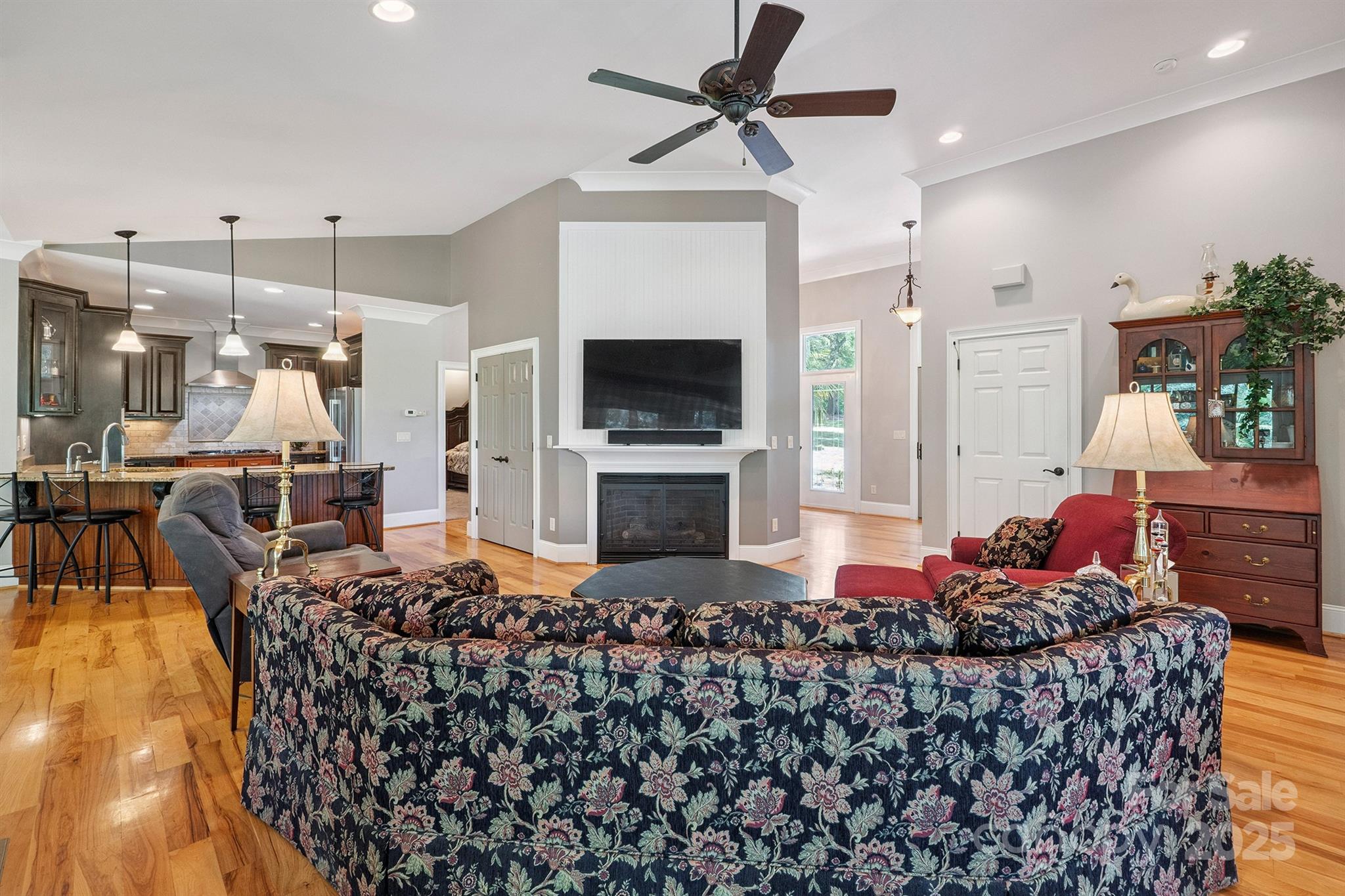 8304 Renee Ford Road Stanfield, NC 28163 - Photo 8 of 30 a living room with furniture a flat screen tv and a fireplace