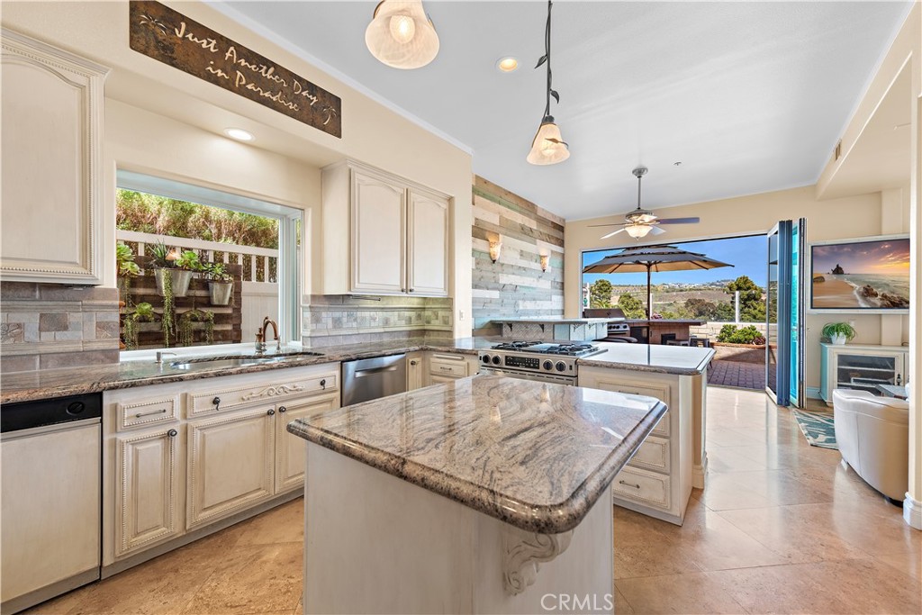 33852 Bridgehampton Drive Dana Point, CA 92629 - Photo 16 of 51 a kitchen with granite countertop a stove and white cabinets