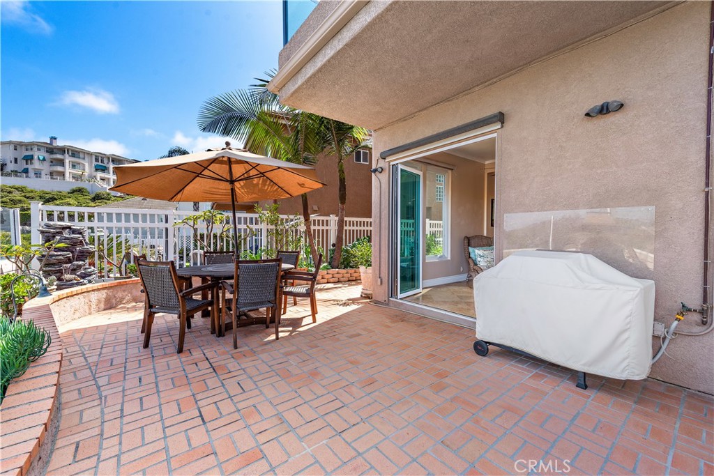 33852 Bridgehampton Drive Dana Point, CA 92629 - Photo 23 of 51 a view of a patio with a table and chairs under an umbrella