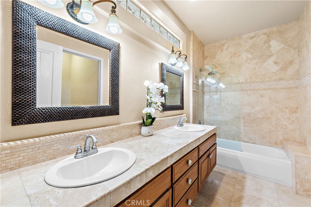 33852 Bridgehampton Drive Dana Point, CA 92629 - Photo 34 of 51 a bathroom with a granite countertop sink a mirror and a bathtub