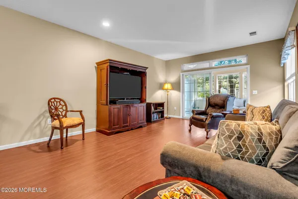 a living room with furniture a table and a large window