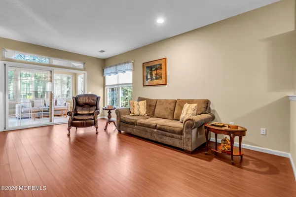 a living room with furniture and floor to ceiling windows