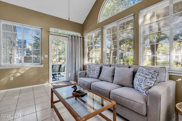a living room with furniture windows and a dining table