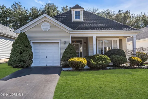 a front view of a house with a garden