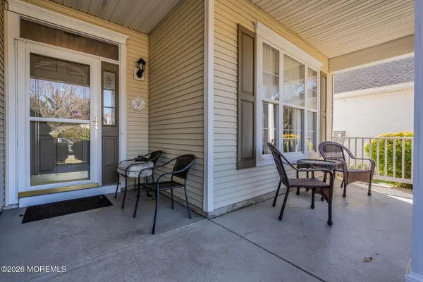 a view of a house with patio and a yard