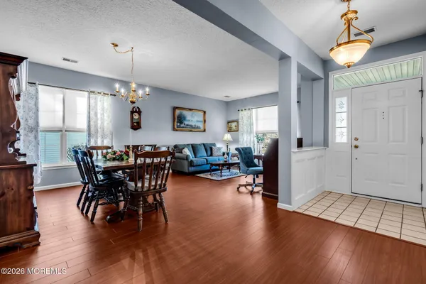 a living room with furniture a dining table and a potted plant