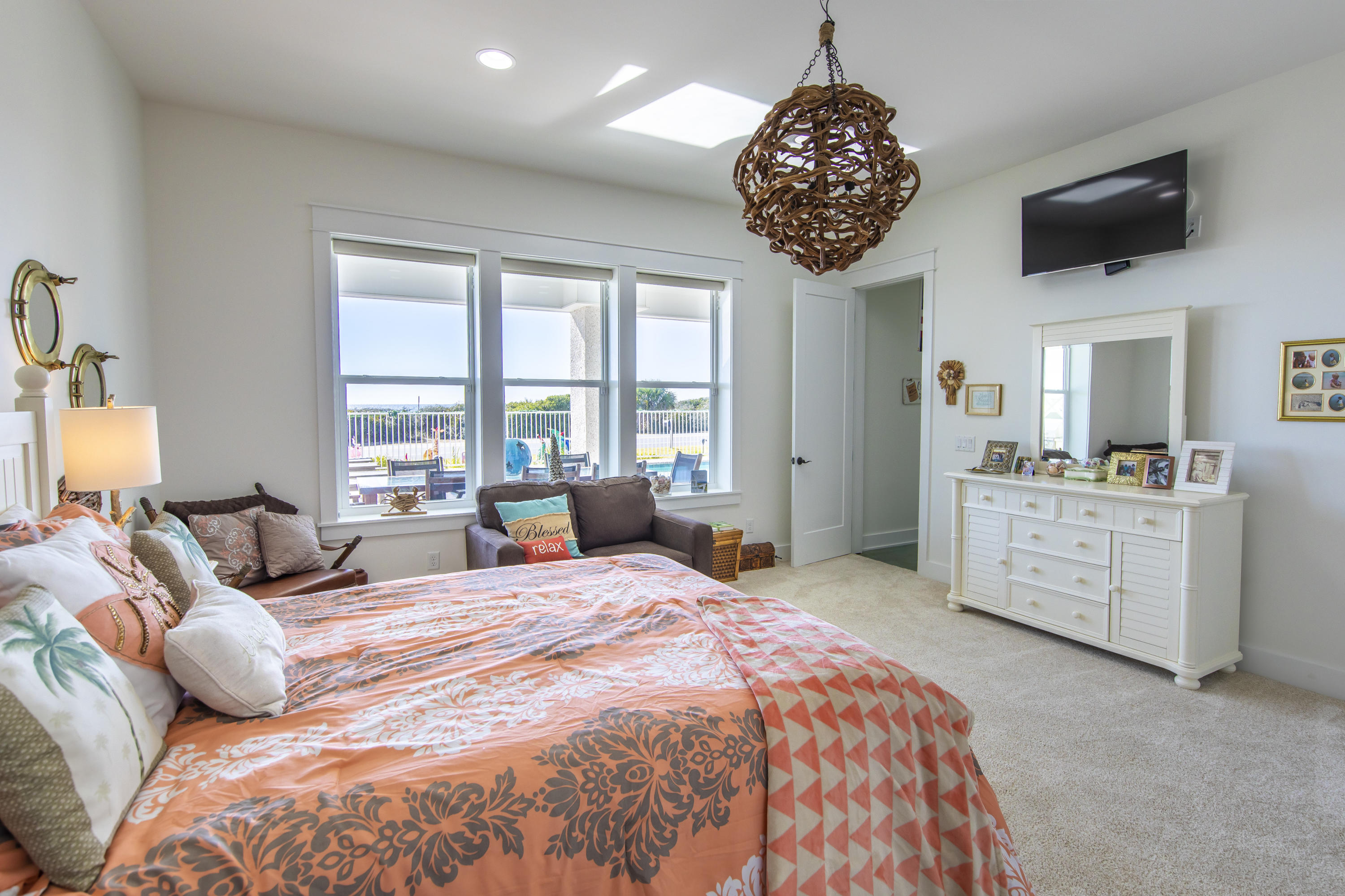 21222 Front Beach Road Panama City Beach, FL 32413 - Photo 14 of 60 a spacious bedroom with a large bed a flat screen tv and windows