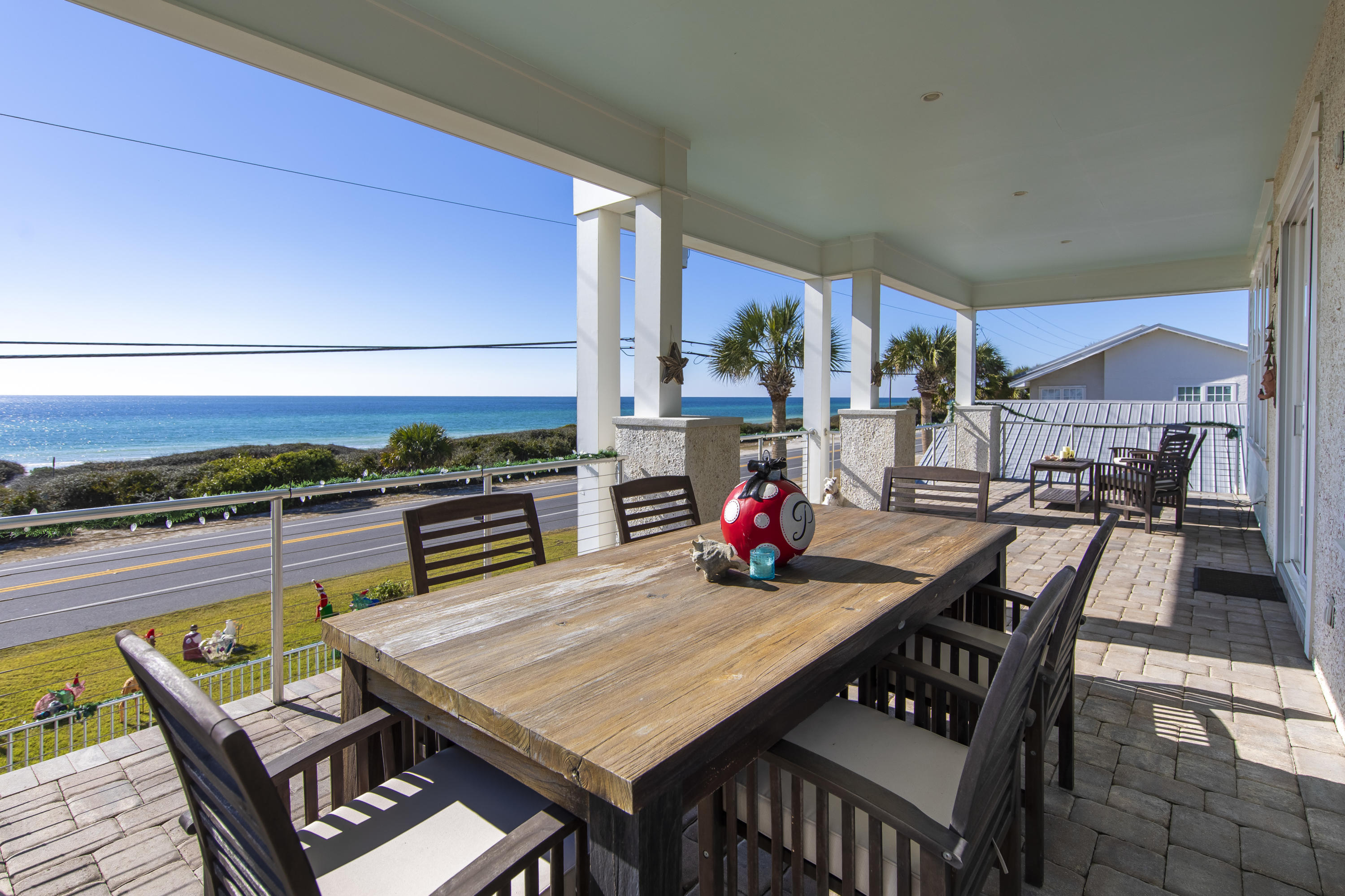 21222 Front Beach Road Panama City Beach, FL 32413 - Photo 21 of 60 a view of a dining table and chairs in the patio