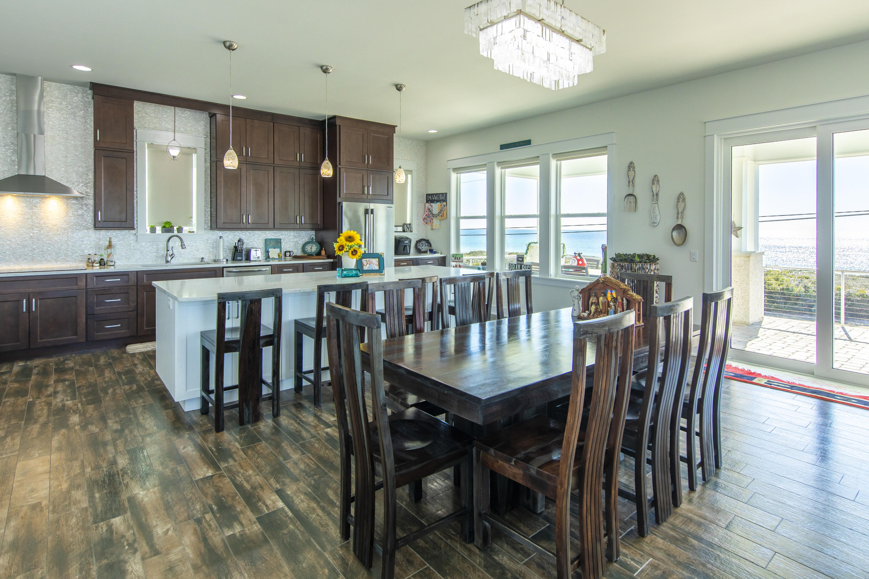 21222 Front Beach Road Panama City Beach, FL 32413 - Photo 31 of 60 a view of a dining room with furniture window and wooden floor