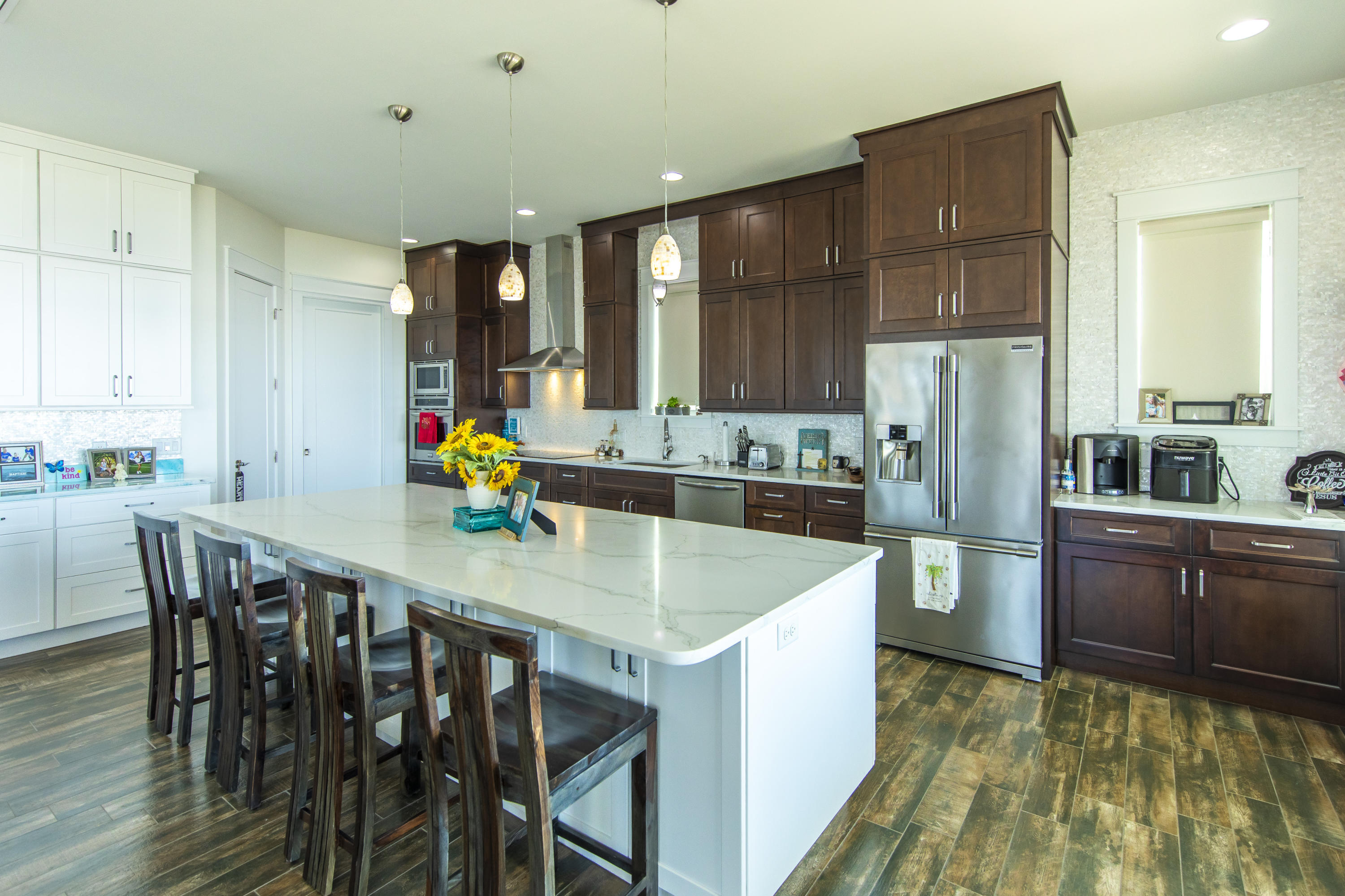 21222 Front Beach Road Panama City Beach, FL 32413 - Photo 32 of 60 a kitchen with stainless steel appliances granite countertop a table chairs sink and cabinets