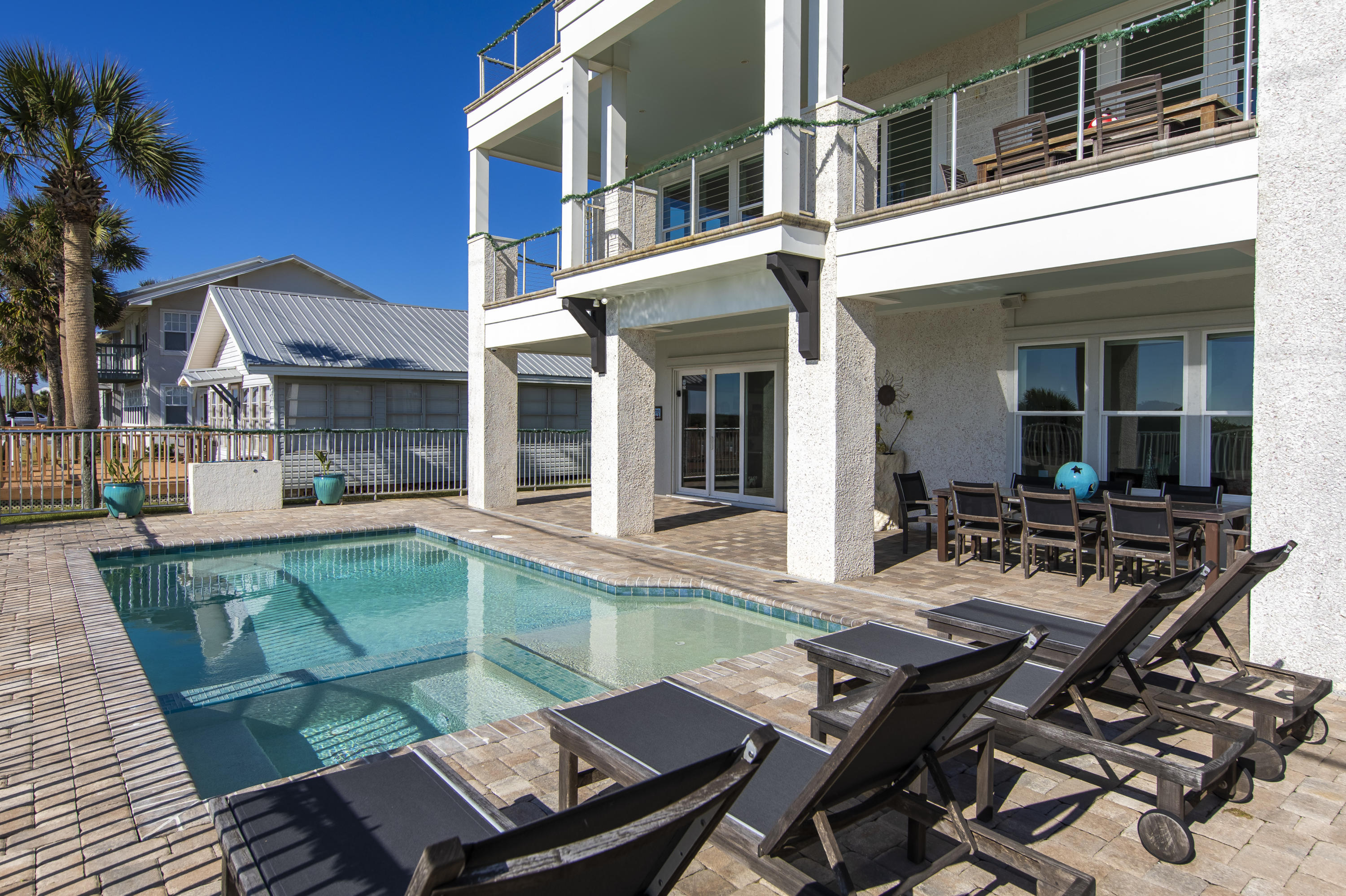21222 Front Beach Road Panama City Beach, FL 32413 - Photo 4 of 60 a view of a patio with table and chairs and potted plants