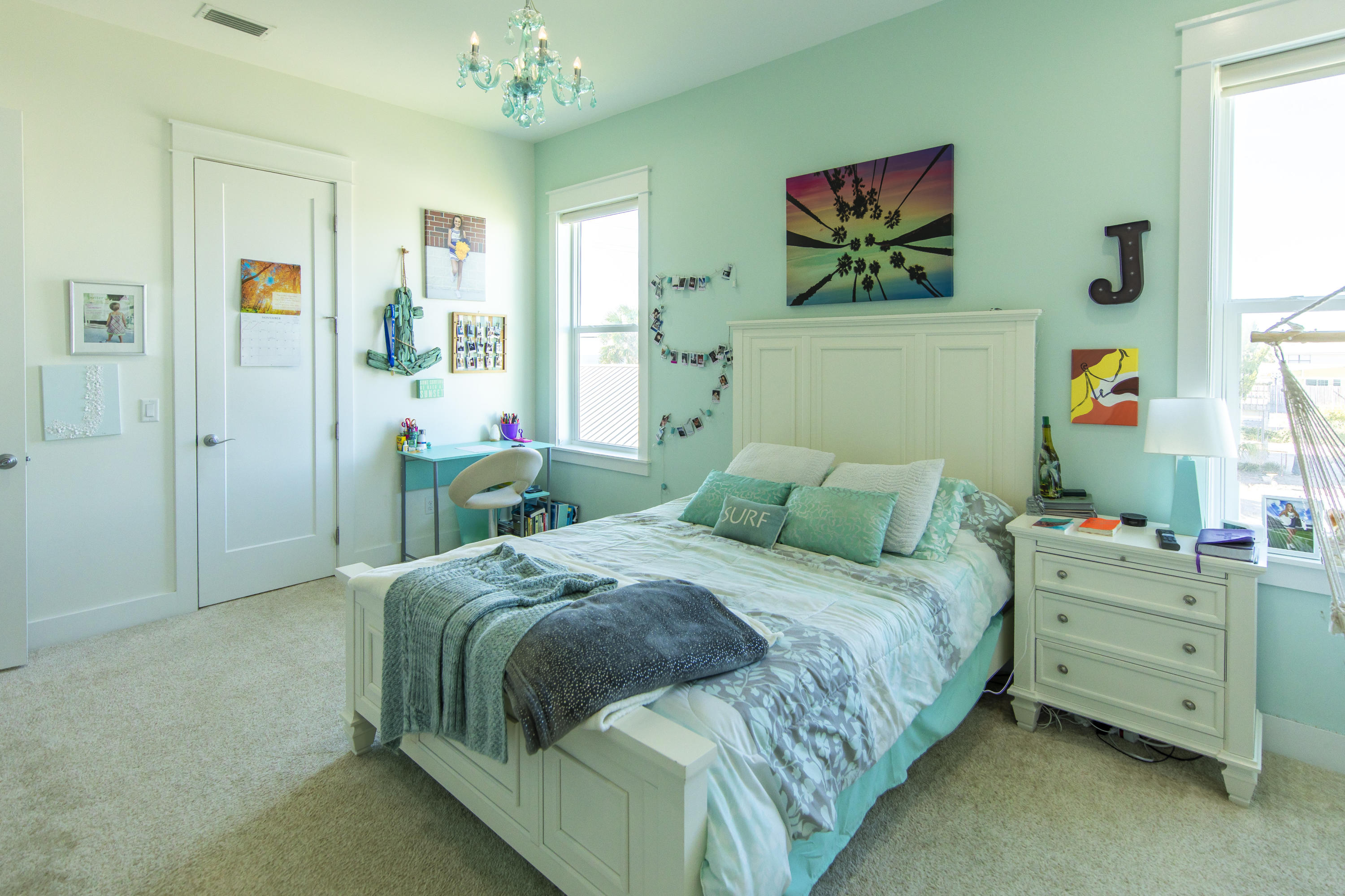 21222 Front Beach Road Panama City Beach, FL 32413 - Photo 42 of 60 a bedroom with a bed and a chandelier