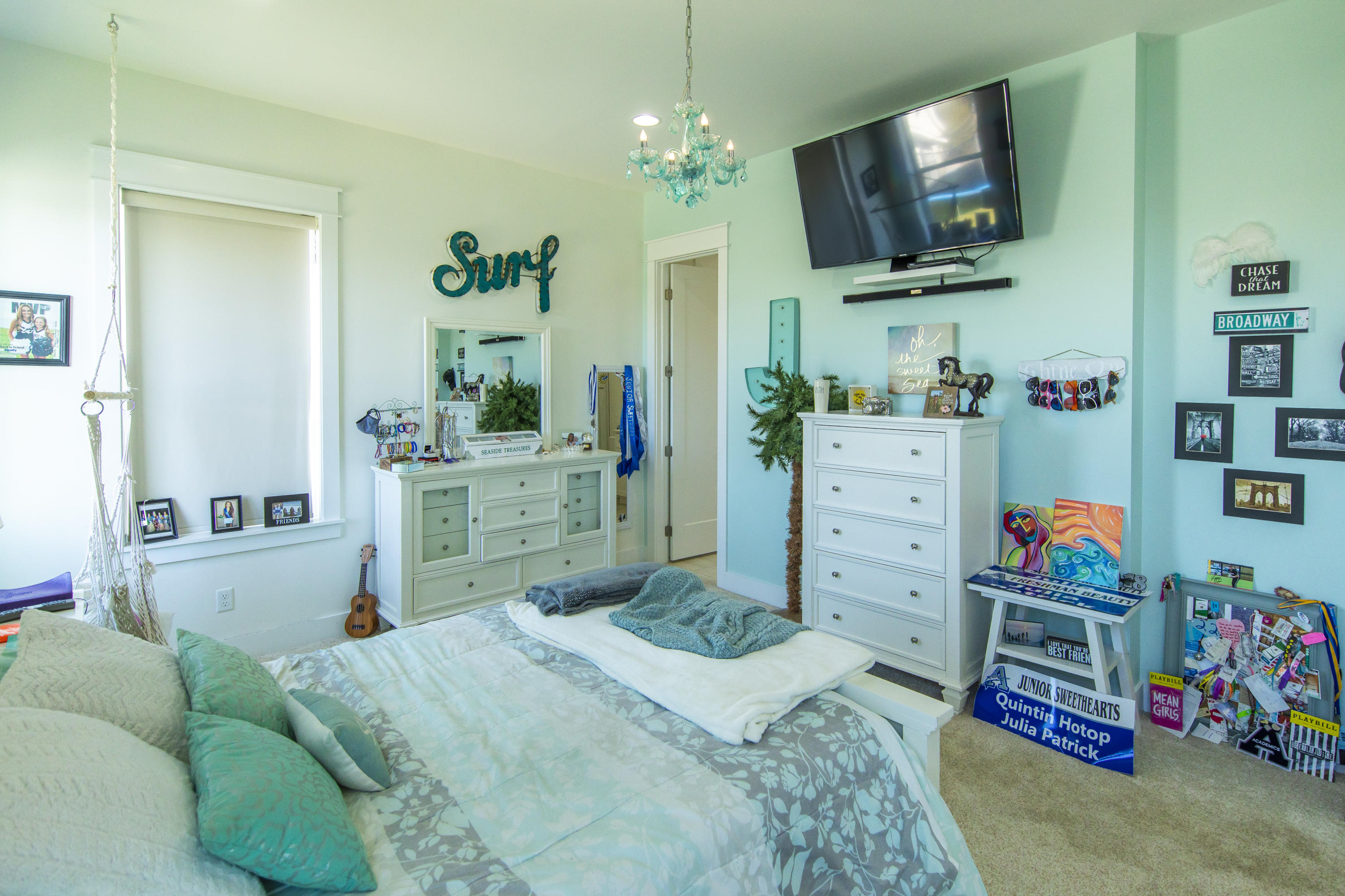 21222 Front Beach Road Panama City Beach, FL 32413 - Photo 43 of 60 a bedroom with a bed a flat screen tv and a couch