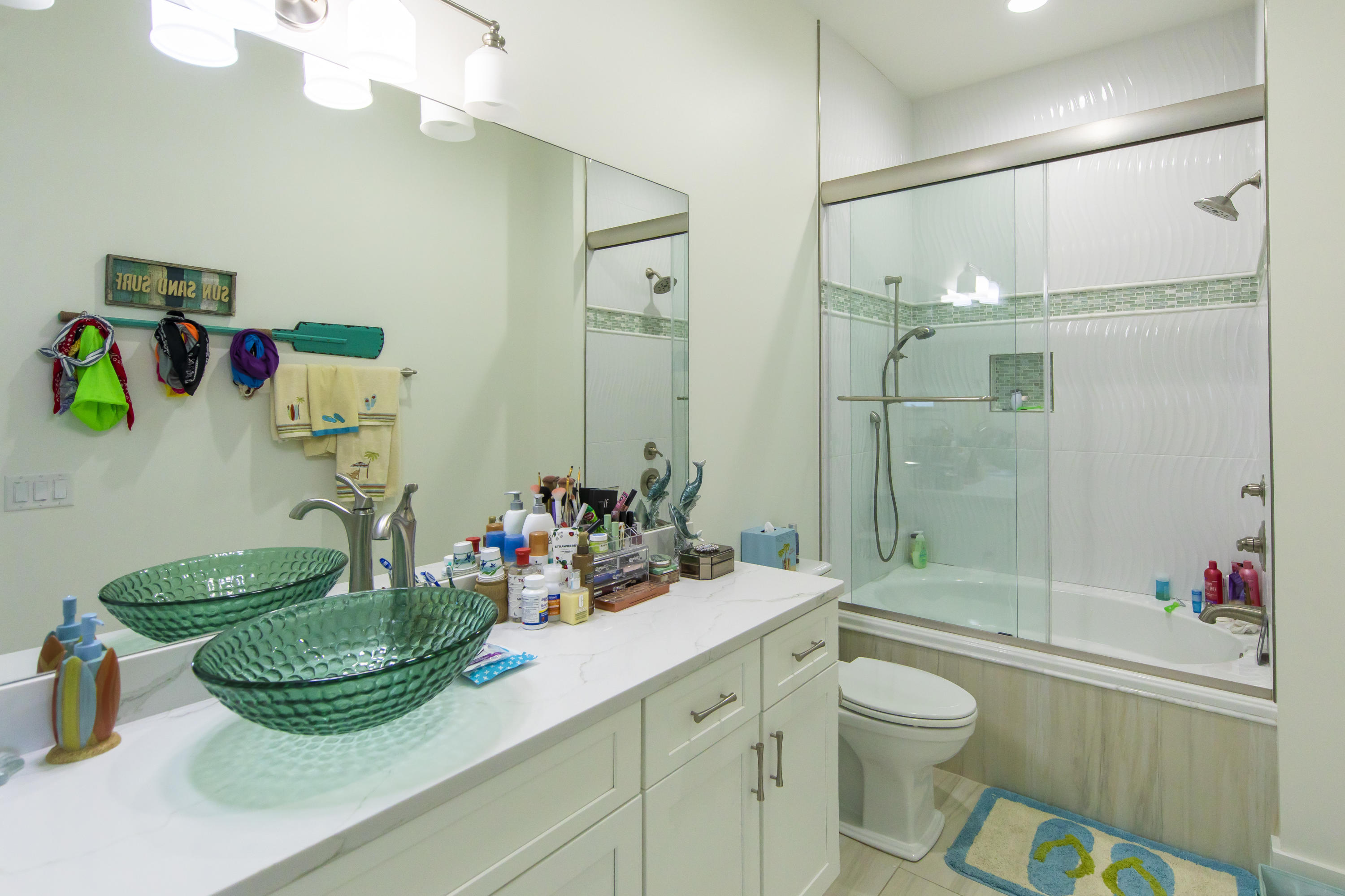 21222 Front Beach Road Panama City Beach, FL 32413 - Photo 44 of 60 a bathroom with a mirror sink and toilet