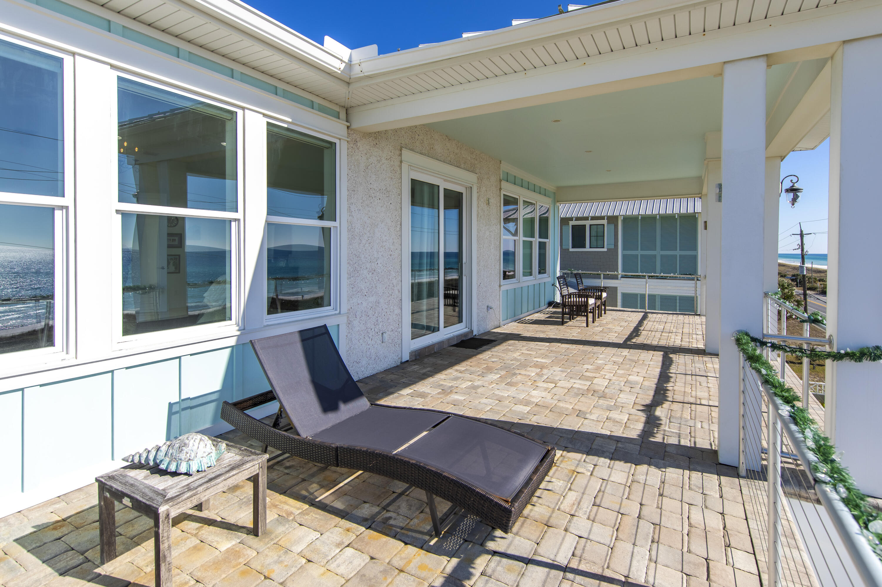 21222 Front Beach Road Panama City Beach, FL 32413 - Photo 46 of 60 a view of a patio with table and chairs and potted plants