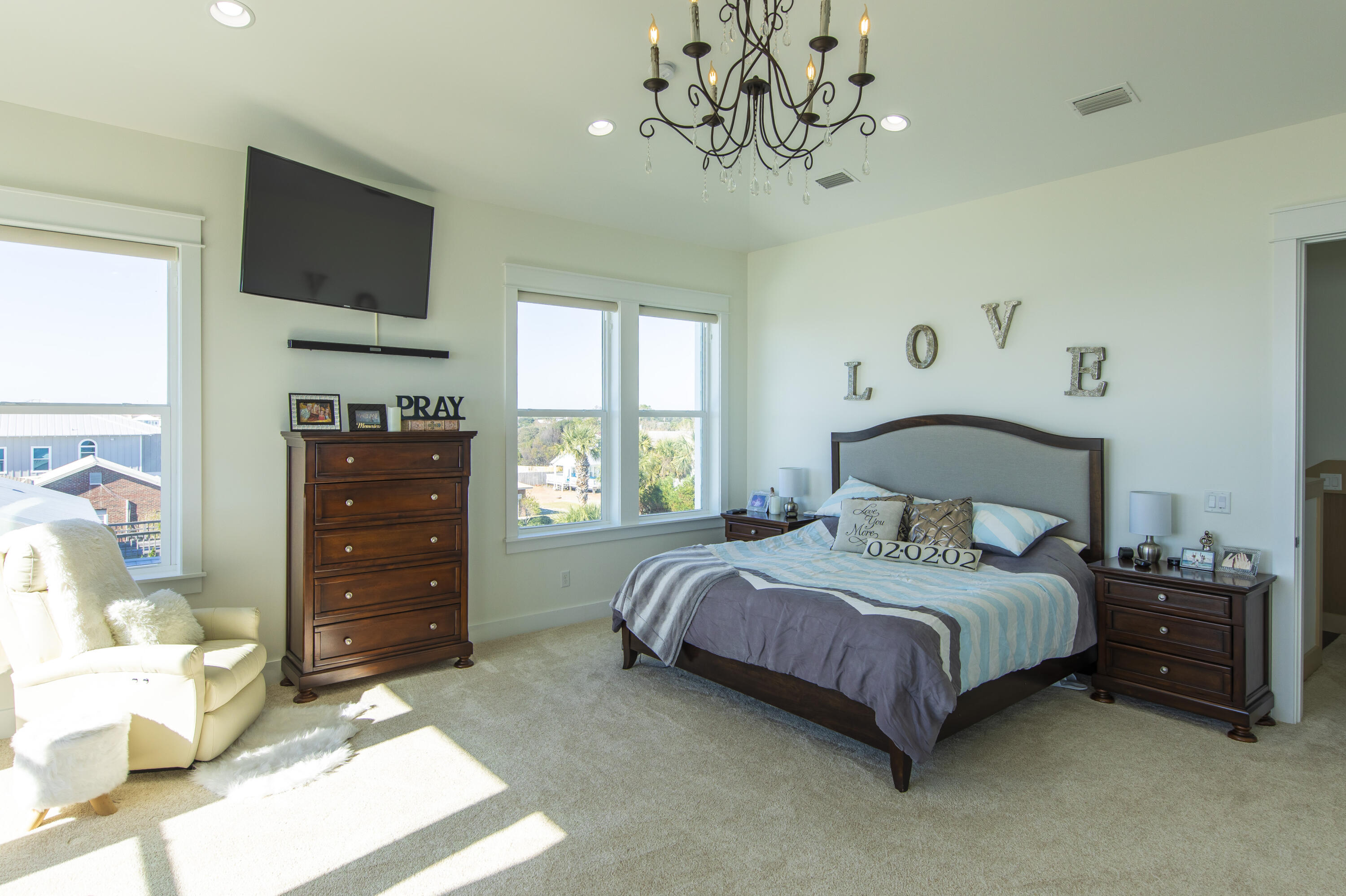 21222 Front Beach Road Panama City Beach, FL 32413 - Photo 51 of 60 a bedroom with a bed and a flat tv screen on dresser