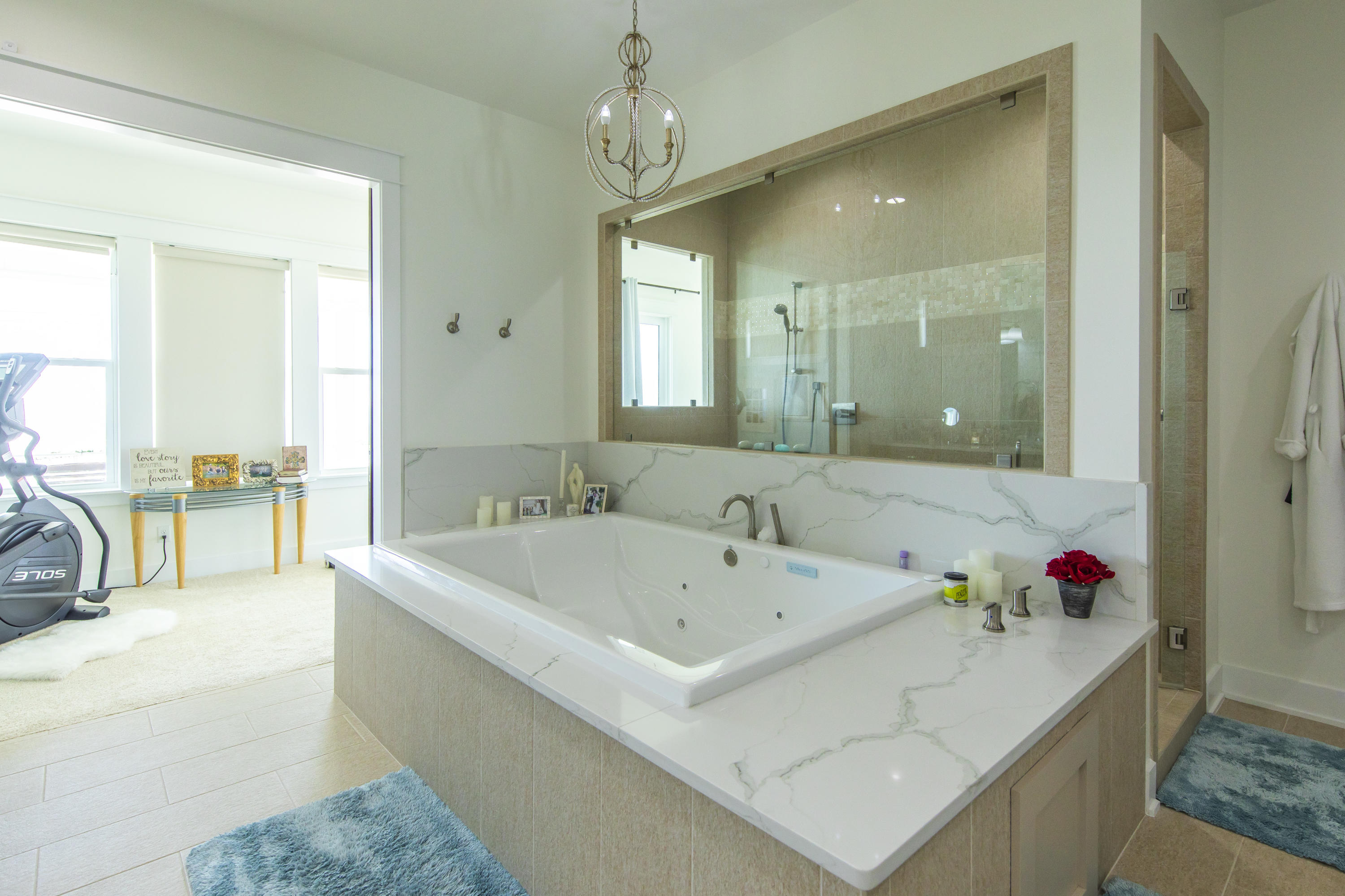 21222 Front Beach Road Panama City Beach, FL 32413 - Photo 56 of 60 a bathroom with a tub a sink and a large mirror
