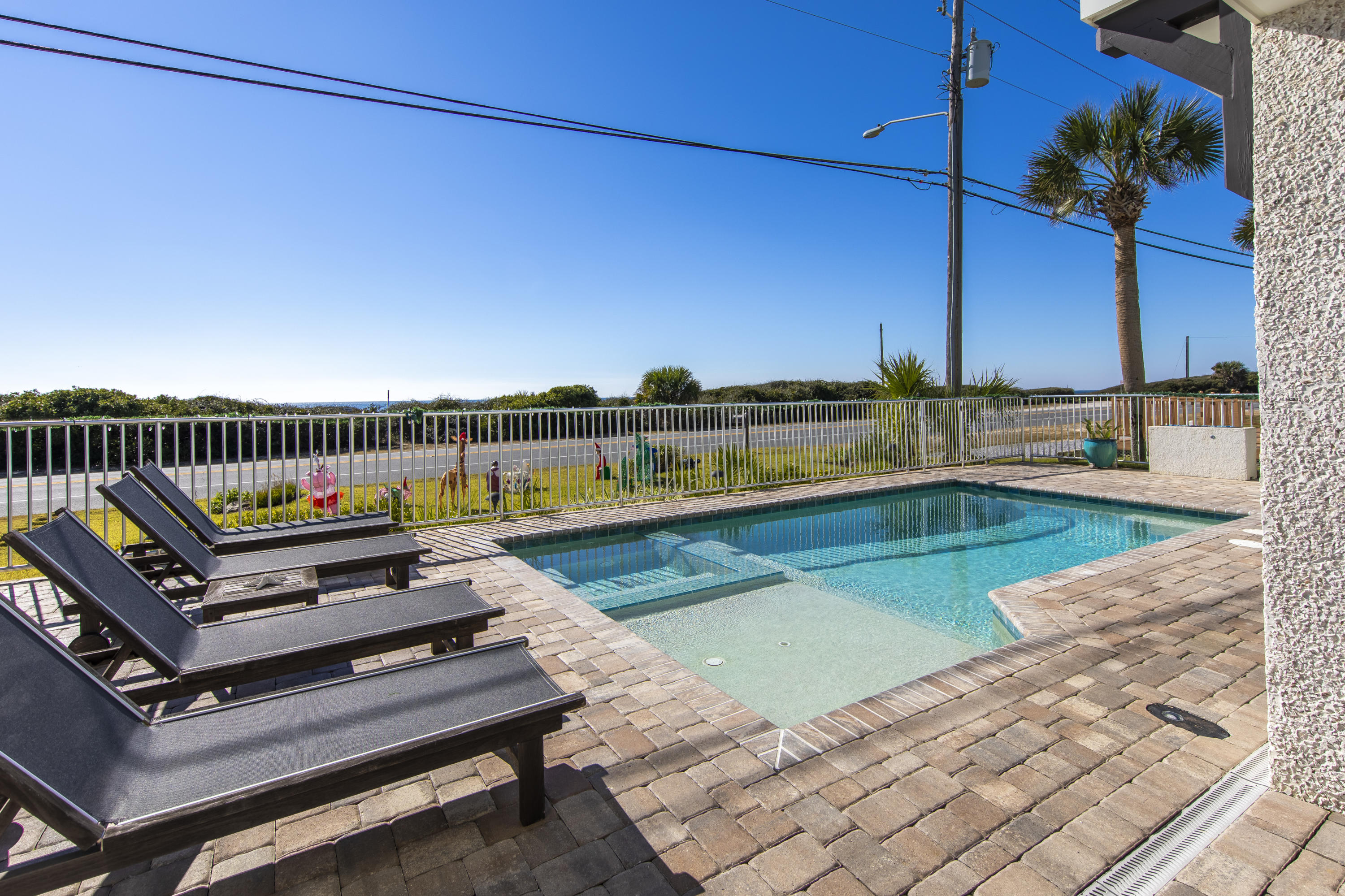 21222 Front Beach Road Panama City Beach, FL 32413 - Photo 6 of 60 a view of a swimming pool with a lounge chairs