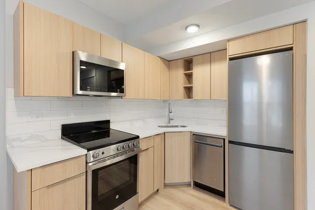 a kitchen with a refrigerator sink and microwave
