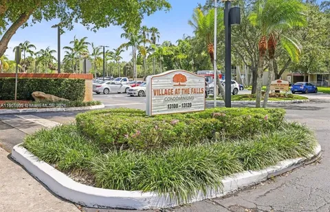 a view of a garden with a fountain and a slide