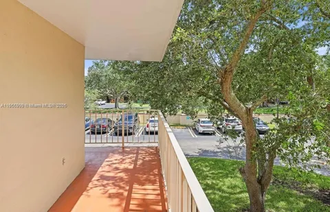a balcony with couch and trees