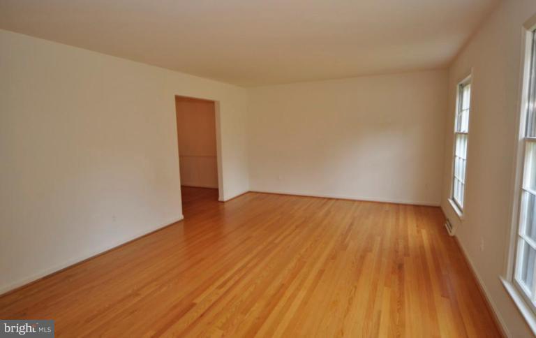 13601 Floris Street Herndon, VA 20171 - Photo 2 of 20 a view of an empty room with wooden floor