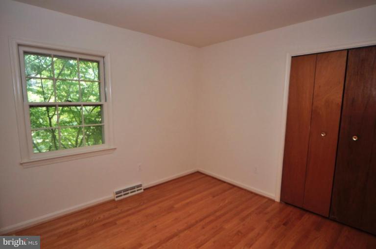 13601 Floris Street Herndon, VA 20171 - Photo 11 of 20 an empty room with wooden floor and windows