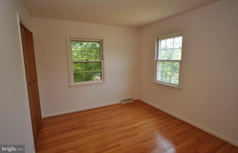 13601 Floris Street Herndon, VA 20171 - Photo 12 of 20 an empty room with wooden floor and windows