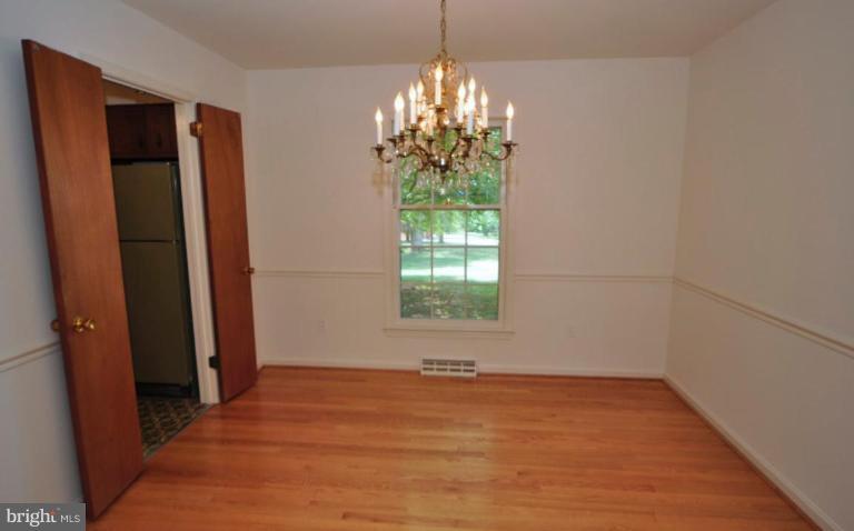 13601 Floris Street Herndon, VA 20171 - Photo 4 of 20 an empty room with windows and chandelier