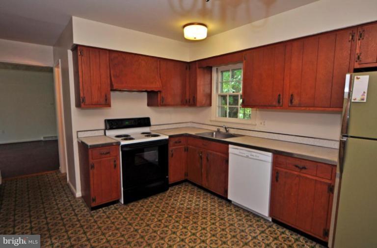 13601 Floris Street Herndon, VA 20171 - Photo 5 of 20 a kitchen with a stove sink and cabinets