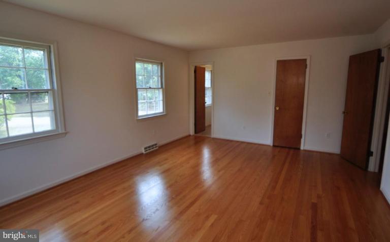 13601 Floris Street Herndon, VA 20171 - Photo 10 of 20 a view of an empty room with wooden floor and a window