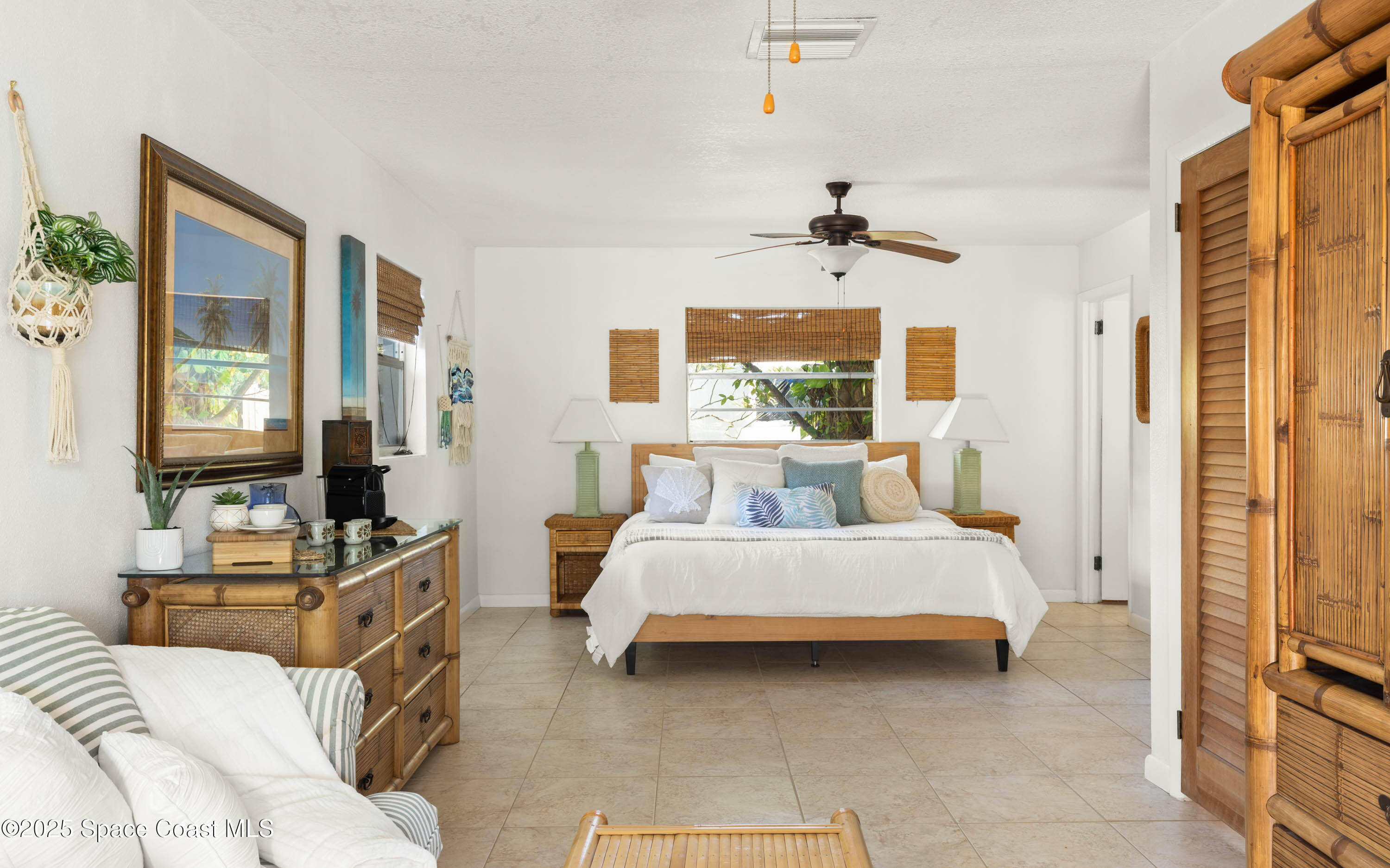 124 Aucila Road Cocoa Beach, FL 32931 - Photo 11 of 58 a bedroom with a bed couch and a window