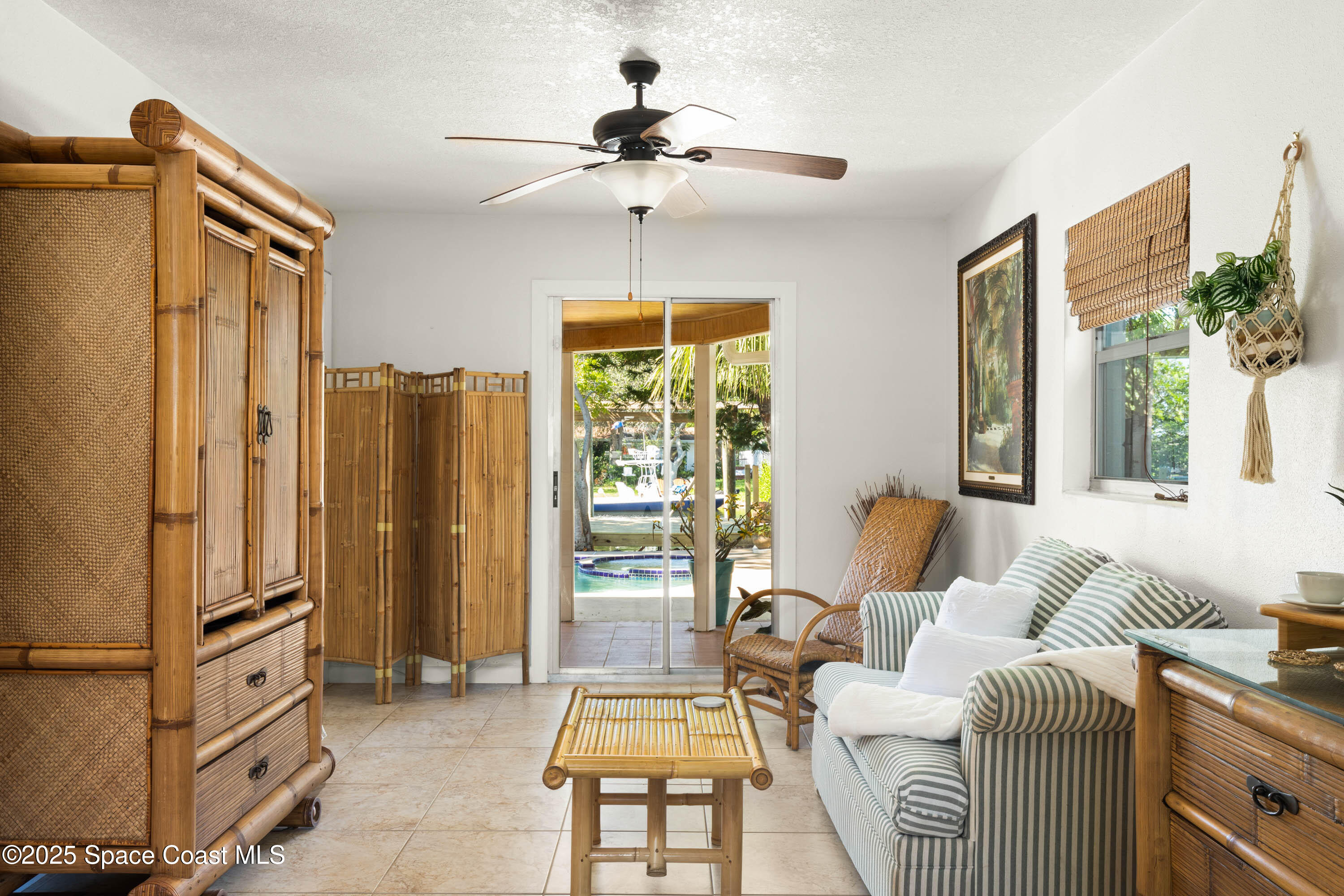 124 Aucila Road Cocoa Beach, FL 32931 - Photo 12 of 58 a living room with furniture and a chandelier