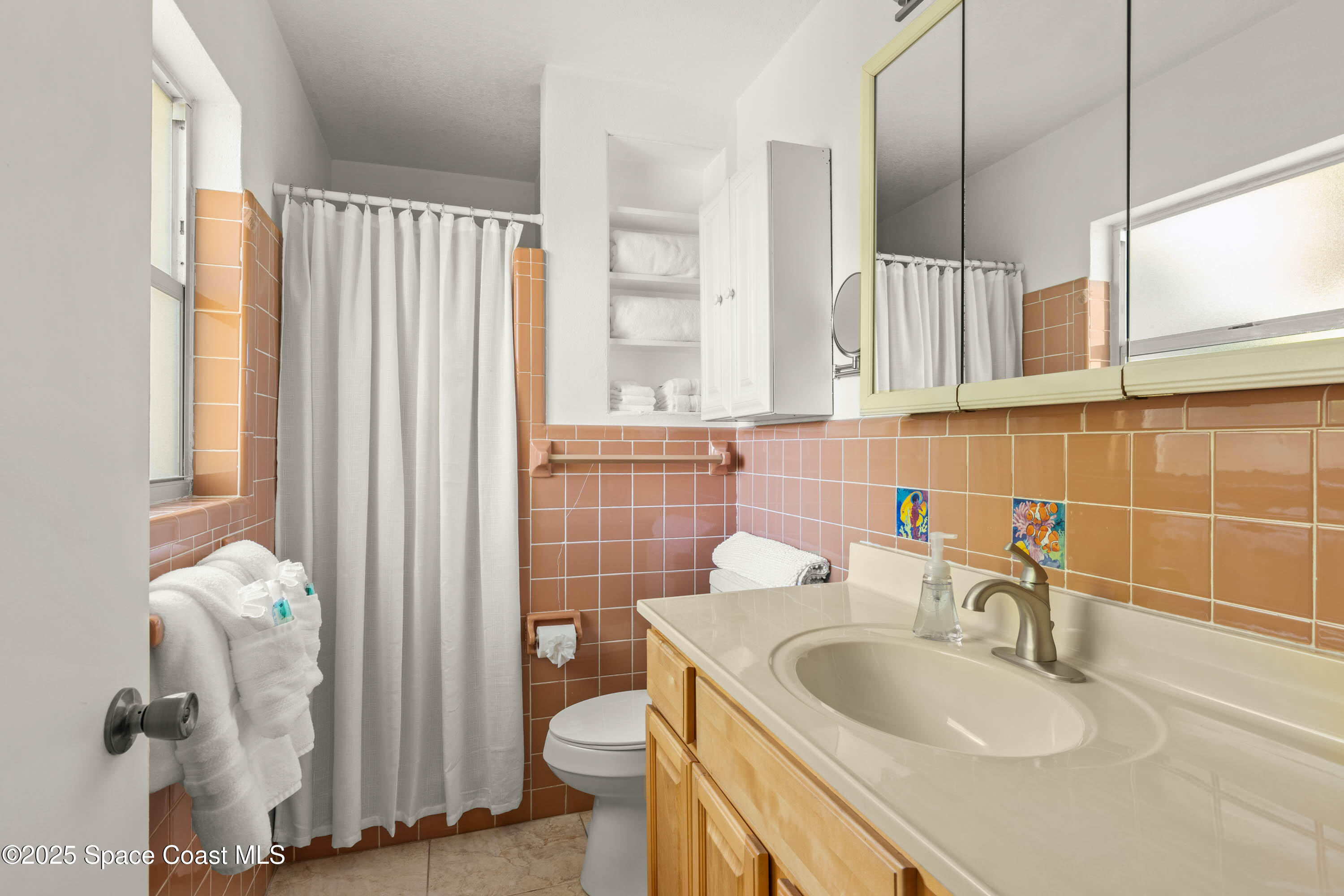 124 Aucila Road Cocoa Beach, FL 32931 - Photo 13 of 58 a bathroom with a sink toilet and shower
